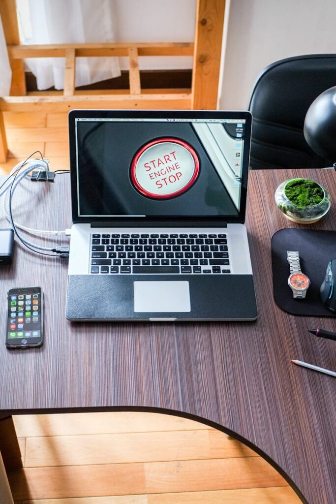 A contemporary office desk setup with laptops, gadgets, and accessories, creating a tech-savvy workplace.